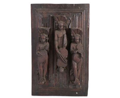 16th Century oak linen fold panel, mounted by three carved putti musicians holding instruments and capped with scallop shells