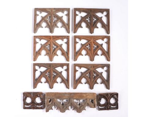 Collection of Gothic oak rood screen panel sections, decorated with pierced tracery work arches, the largest 43cm wide (9)