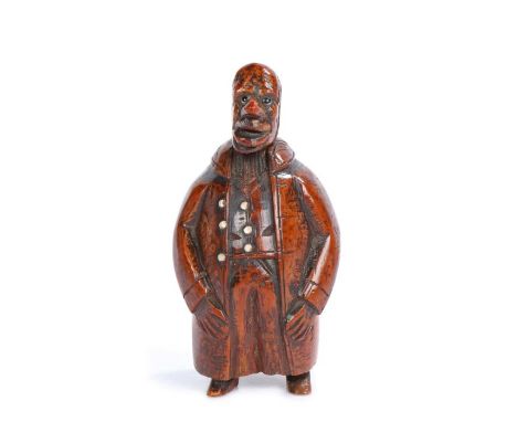 Late 18th Century treen figural coquilla nut snuff box, the figure with a long nose and glass eyes above a portly body his ha