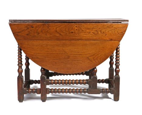 Unusual early 18th Century oak gateleg table, the oval hinged top with drawer to either side above the tapering bobbin turned