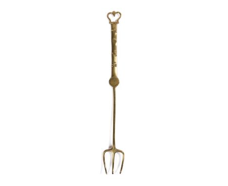 A brass meat fork, circa 1800, with three curving tines, the stem with a cusp discoid below a flattened handle decorated with