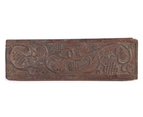 17th Century oak panel, the rectangular body decorated with fruits and scrolling flowers within a thick border, 55cm x 18cm&n