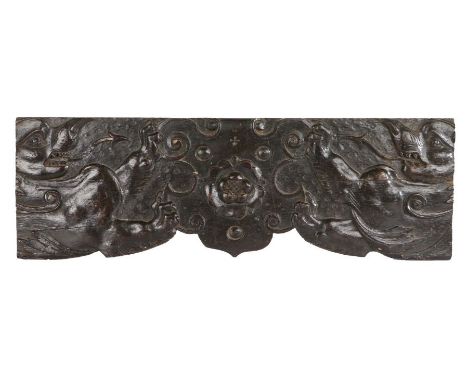 An unusual 16th Century oak panel, English, designed with a central Tudor Rose flanked by mythical beasts with lions’ paws an