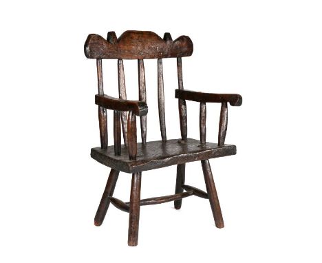 Primitive 18th Century oak stick back chair, Welsh, of substantial proportions, the arched top rail above five chunky spindle