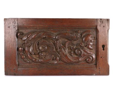 16th century carved oak door, circa 1570, the deeply carved panel with scrolling leaves and fruit, headed by a profile portra