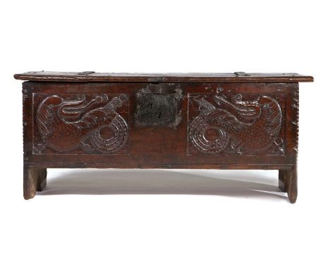 A good 17th Century oak coffer, Lancashire, the rectangular top with iron strapped hinges above a pair of carved panels to th