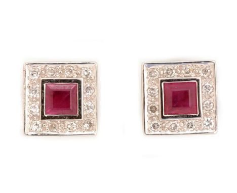 A pair of ruby and diamond cluster earrings, each set with square step cut ruby surrounded by brilliant cut diamonds, in 18ct