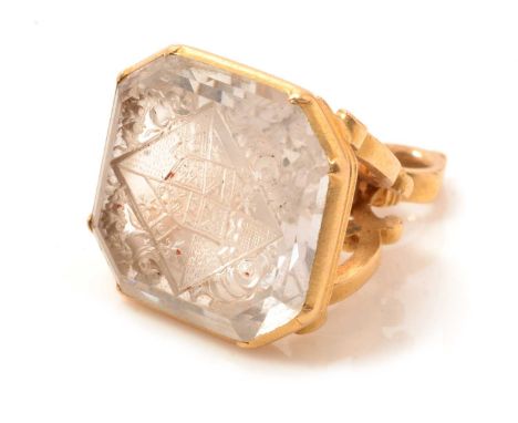 A 19th Century rock crystal fob seal, the canted rectangular rock crystal matrix carved with a full coat of arms, quartered-s