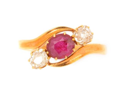 An Edwardian ruby and diamond ring, the oval facet cut ruby measuring 6.2 x 5.5 x 2.7mm, flanked by old-cut diamonds weighing