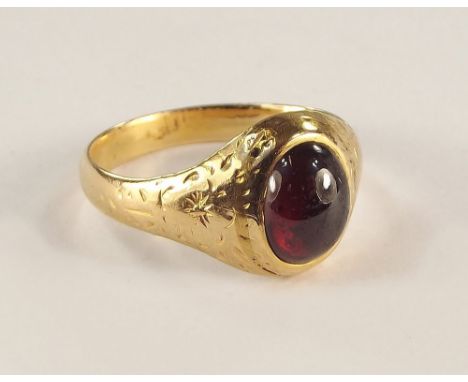 VICTORIAN RING. A Victorian engraved yellow metal ring, set a cabouchon garnet. Size Q.