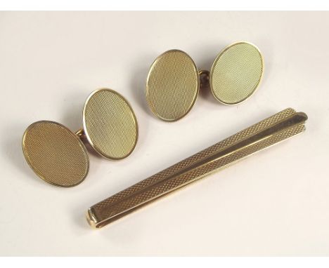 CLIP & CUFFLINKS. A 9ct. gold engine turned tie clip & a pair of 9ct. gold cufflinks. Approx. 19.2g.