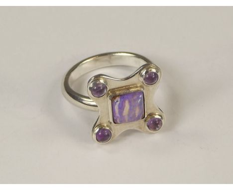 OPAL & AMETHYST RING.A hand made silver ring, set a central lavender boulder opal & four cabouchon amethysts. Size K.