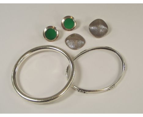 BANGLES ETC.An engraved silver bangle, an oval silver bangle with 'knot' decoration & two pairs of contemporary silver earrin