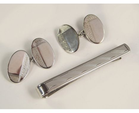 CLIP & CUFFLINKS. A pair of silver engine turned cufflinks & a chromium tie clip.