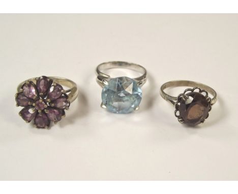 DRESS RINGS. Two silver dress rings, an amethyst flower & smoky quartz & one other dress ring.