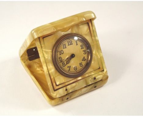 BEDSIDE CLOCK. A small, brass mounted, Art Deco bedside clock, in marbled celluloid travelling case.