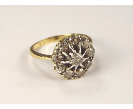 DIAMOND RING. An 18ct. gold cluster diamond ring, set with ten old cut diamonds. Diameter of setting 1.5cm. Size M.