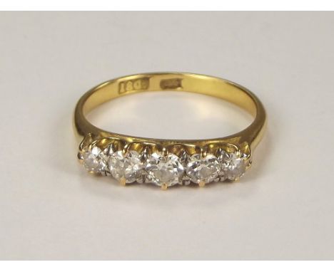 DIAMOND RING. An 18ct. gold & platinum five stone diamond ring. Size M/N. Approx 3g.