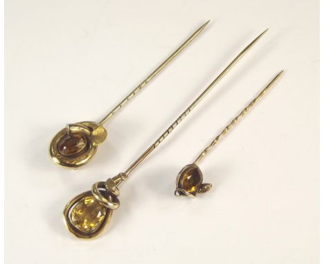 STICKPINS. A Victorian citrine set stick pin & two stone set stick pins, one with serpent mount.