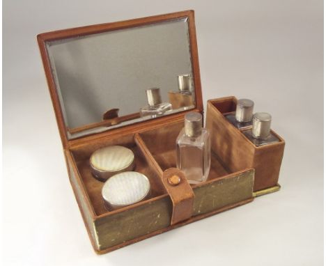 TOILET BOTTLES.A leather book shaped case entitled 'Beauty's Aids', containing a pair of Art Deco silver mounted toilet jars 
