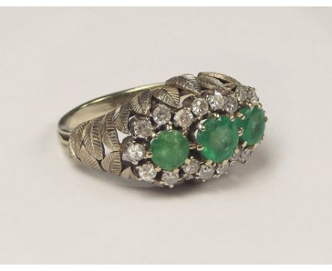 EMERALD RING. A hand made 18ct. white gold emerald & brilliant cut diamond dress ring. 18 x 2mm diamonds. Size O.