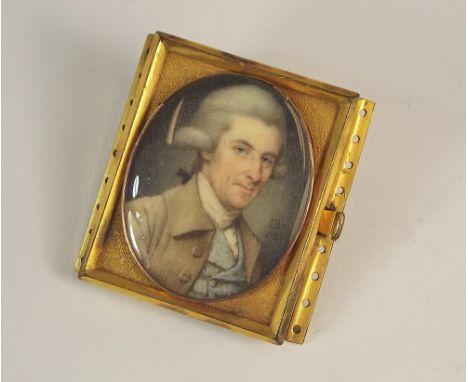 PORTRAIT MINIATURE.A late 18th century portrait miniature, painted on ivory, of a gentleman in a grey wig, a blue waistcoat &