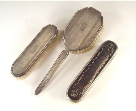 BRUSHES.Two engine turned brushes inscribed 'Betty' & an early 20th century silver & tortoiseshell mounted brush. 