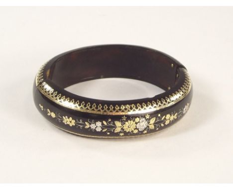 PIQUE BANGLE. A Victorian tortoiseshell pique, inlaid, oval bangle. (Elasticated)