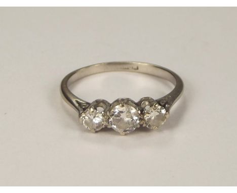 DIAMOND RING. A platinum three stone diamond ring, the central stone approx. 0.35ct. spread. Size L/M.