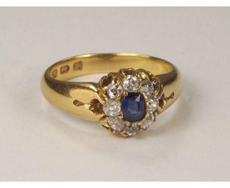 GOLD RING. A Victorian 18ct. gold sapphire & diamond cluster ring. Size M. Approx. 4.9g.