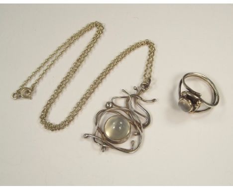 MOONSTONE.A handmade cabouchon moonstone pendant, on silver chain & a similar ring set in unmarked silver & gold.