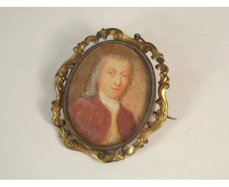 PORTRAIT MINIATURE. A portrait miniature of an 18th century gentleman, in grey wig & red top coat. 5.2 x 4.3cm. Unsigned & in