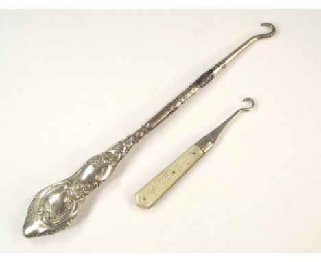 BUTTON HOOKS.An Edwardian silver & mother of pearl folding button hook & one other silver mounted button hook.
