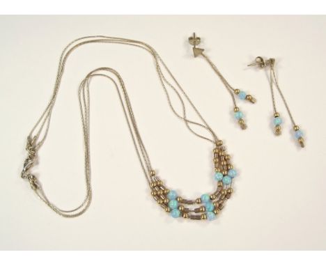 OPAL SET. A modern three strand opal bead necklace with matching drop earrings.