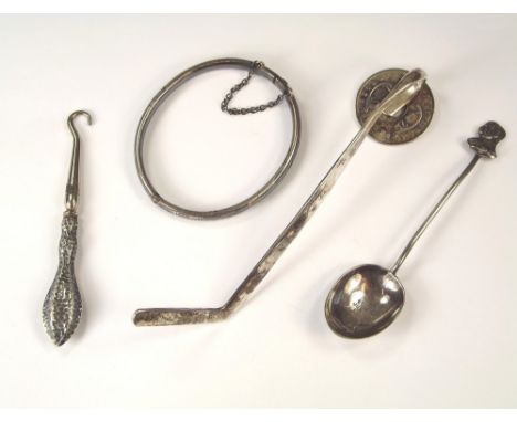 MISCELLANEOUS.A child's engraved silver bangle, a silver mounted glove hook, a 1935 silver jubilee spoon and a Kenyan silver 