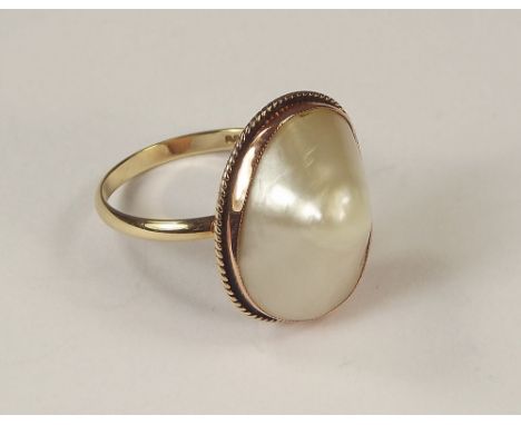 MABE PEARL RING. A hand made Mabe pearl dress ring in 9ct. rose gold, rub-over setting.