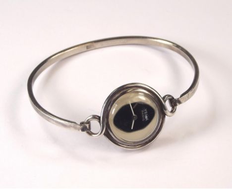 BANGLE WATCH. A lady's silver bangle watch by Yema, with bi-coloured dial.