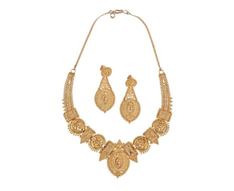 
	
		AN INDIAN NECKLACE AND EARRINGS 
		The necklace with articulated shaped panels and beaded decoration, stamped ml 22CT, t
