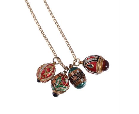 
	
		FOUR ENAMELLED EGG PENDANTS 
		The first with a red and black enamelled setting with white stone accents and a cabochon 