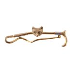 A 9 CARAT GOLD FOX MASK AND CROP STOCK PIN