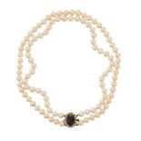 A TWO ROW CULTURED PEARL NECKLACE WITH GARNET 9CT GOLD CLASP, LONDON 1992