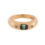 AN EMERALD AND DIAMOND THREE STONE BAND RING, LONDON 1990