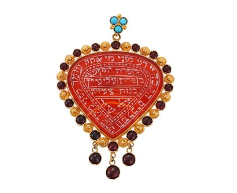 
	
		AN AGATE AND GARNET PENDANT 
		The pear shaped cornelian panel engraved with Hebrew inscriptions, within a cabochon garn