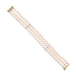 A FRENCH THREE STRAND CULTURED PEARL BRACELET WITH A DIAMOND CLASP