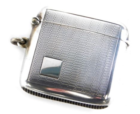 A George V silver Vesta case, of oblong form, engine turned with vacant cartouche, side ring handle, with match strike base, 