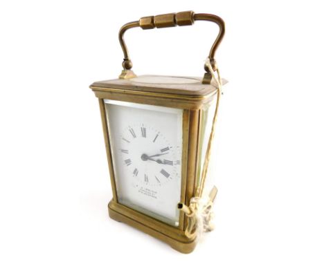 An early 20thC brass carriage clock, the 6cm wide plate stencilled with a Roman numeric dial and marked FJ Reich Tontine Stre
