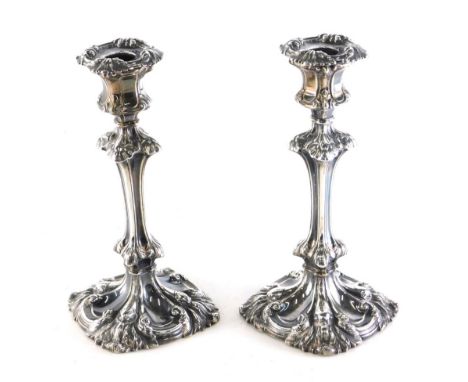 A harlequin pair of William IV candlesticks, by Henry Wilkinson &amp; Co, each repousse decorated with leafy scroll removable