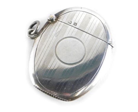 An Edward VII silver Vesta case, of oval form, with hinged lid, partially engine turned with side ring handle, with match str