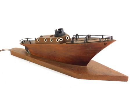 An Art Deco wooden boat table lamp, with electrical fitting on diamond shaped base, 14cm high.