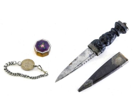 A Scottish dagger, with heavily carved turned handle, compressed pommel and razor edge blade, with pressed scabbard with meta